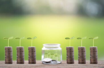 Money saving, Hand putting coin in glass jar with coins inside For now and future 