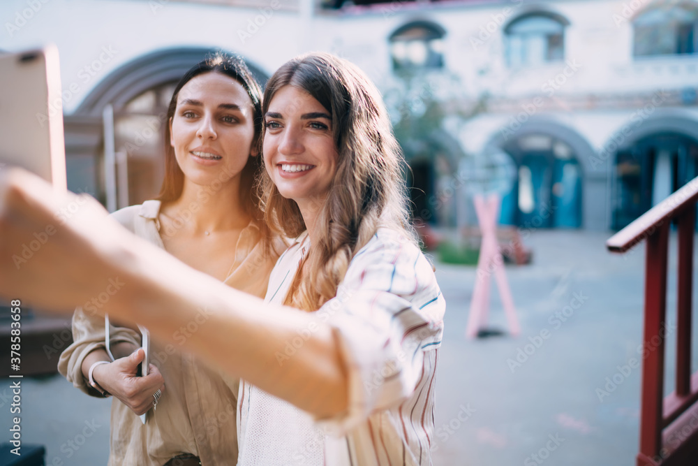 Poster happy caucasian bloggers smiling at front smartphone camera while making selfie content for network 