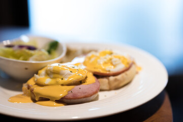 Weekend vegetarian breakfast in Scotland with two eggs benedict on homemade muffins with spinach and yellow hollandaise sauce.