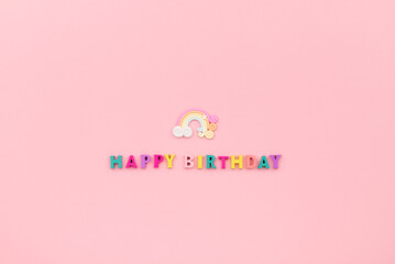 Happy birthday inscription from wooden colorful letters with rainbow