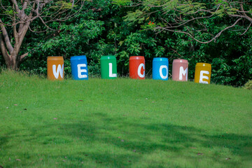
Welcome letters written on a large bucket in the park.