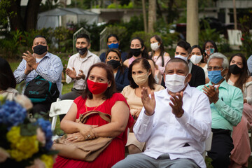 Personas disfrutando de una boda durante la pandemia del coronavirus, llevando puesta la mascarilla