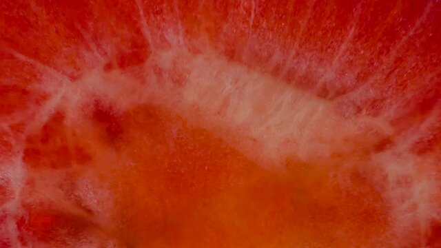 Squeeze Fragrant Strawberry Half. Halves and Whole Strawberries are squeezed and crushed close-up on a bright white background, creating a juicy splash of pulp and juice. Shooting at 120 fps