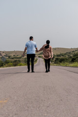 A man and a woman walking on a highway
