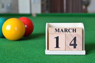 March 14, number cube with balls on snooker table, sport background.
