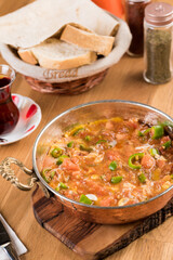 Traditional turkish breakfast food menemen made by eggs and tomatoes.