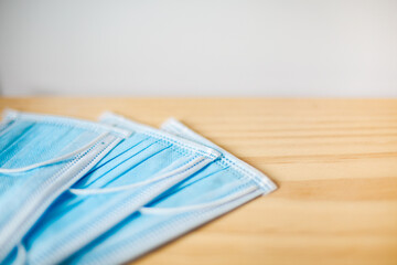 Surgical masks on a neutral wooden or white background to prevent the new covid-19 disease