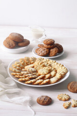 Group of Butter Cookies, on a white plate, on a white wooden table.