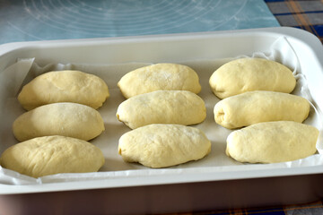 The formed buns are placed on a baking tray.