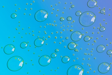 Multiple Drops of water on a colored  background.  in Blue. Selective focus. Gradient