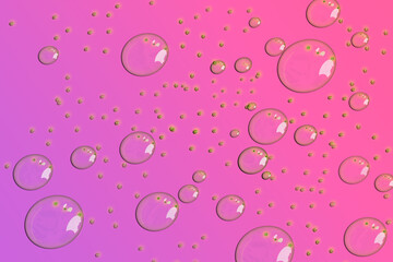 Multiple Drops of water on a colored  background.  in Pink  Selective focus. Gradient