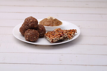 Navratri Upwas sweets food platter dry fruit laddu, groundnut chikki or toffee and sheera.