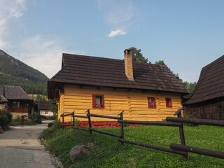 VLKOLINEC, SLOVAKIA, EUROPE, SUMMER 2015. Beautiful rural house with traditional Slovak vanilla painted wooden architecture in the Unesco heritage village of Vlkolinec.