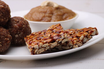 Navratri Upwas sweets food platter dry fruit laddu, groundnut chikki or toffee and sheera.
