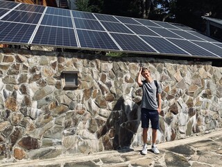 The solar panels on the roof against the guy