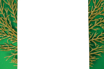 Layout of spruce branches and a white blank sheet of paper with space for text that lies on a green background.
