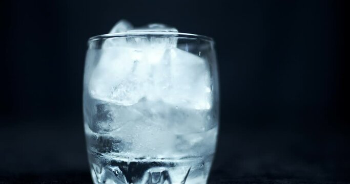 time-lapse pf melting ice cubes in a glass