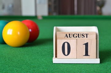 August 1, number cube with balls on snooker table, sport background.