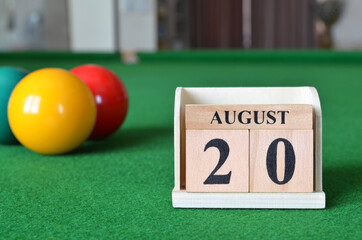 August 20, number cube with balls on snooker table, sport background.