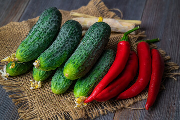 horseradish, dill, pepper, cucumbers for cucumber on a wooden table