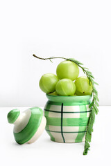Indian gooseberry fruit in pickle jar in white background.