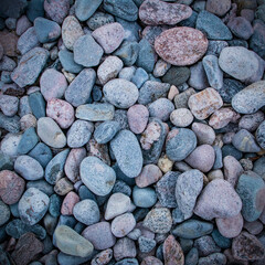 Many colorful round rocks of the coastal area photographed from above