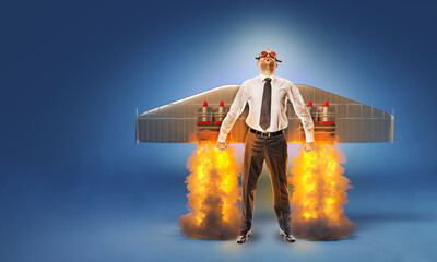 businessman with wings and flares on his back with flames and smoke.