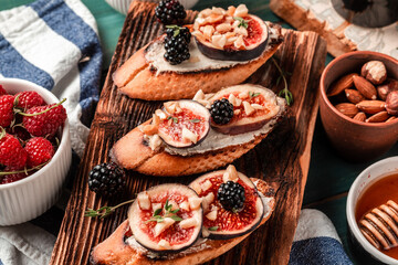 Toasted figs, ricotta cream cheese, thyme, honey. Healthy food concept