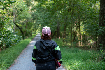 person walking in the woods along a path