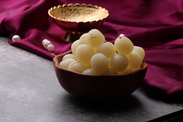Indian Sweet Rasgulla Also Know as Rosogolla, Roshogolla, Rasagola, Ras Gulla, Anguri Rasgulla or Angoori Rasgulla is a Syrupy Dessert Popular in India. It is Madeup with milk.