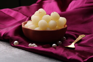 Indian Sweet Rasgulla Also Know as Rosogolla, Roshogolla, Rasagola, Ras Gulla, Anguri Rasgulla or Angoori Rasgulla is a Syrupy Dessert Popular in India. It is Madeup with milk.