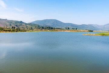 Awesome view of small lake  near a greenery mountain background.
