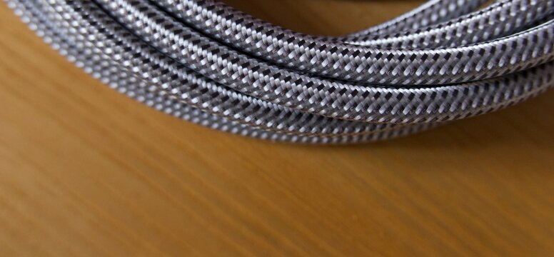 Nylon fabric cable flex against wood background with copy space