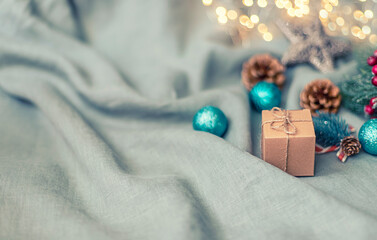 Eco gift box in craft paper branch on linen fabric. Zero waste, plastic free. Christmas, New year gift wrapping.