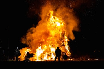 Ancient tradition of Epiphany fires in Friuli, Italy. Burning of a straw effigy. Farewell to winter, arrival of spring