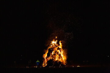 Ancient tradition of Epiphany fires in Friuli, Italy. Burning of a straw effigy. Farewell to winter, arrival of spring