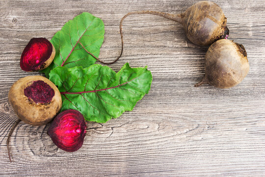 Top view at fresh organic beets with leaves on wooden rustic background. Close up view.