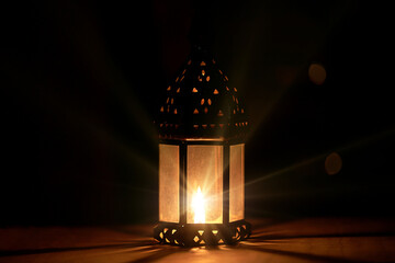 Night scene with vintage lamp. Candle, magic, witchcraft and mysticism. Warm glow in the dark