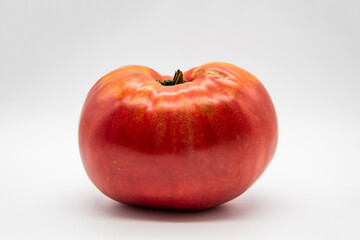 One big ripe red tomato isolated on a white background. Healthy food concept.