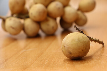 Closeup Longkong on wooden table, tropical fruit in thailand