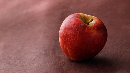red apple on a wooden table