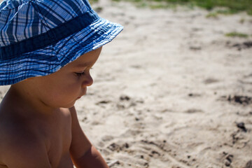a beautiful little child playing in the sand