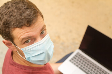 Man teleworking with laptop