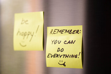 Motivated reminders taped to fridge door
