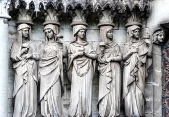 Sculptures above the portal, on the façade of St Finn Barre's Cathedral in Cork, Ireland, built in the 19th  century in Gothic Revival style. 