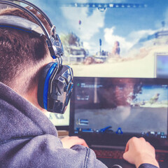 Cybersport,esport.  Professional Gamer Plays in Strategy Video Game on  Computer. Cyber ??Games Tournament, Plays at Home, or Internet Cafe. © shintartanya