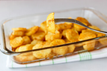Baked potatoes in the oven in large slices