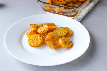 Baked potatoes in the oven in large slices