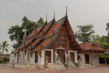 Buddhist temple in Wat Pratu Pong at Lampang Province. An ancient temple decorated with ancient...