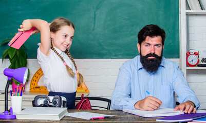 Study is fun. School teacher and schoolgirl. Homeschooling with father. Reward and punishment...